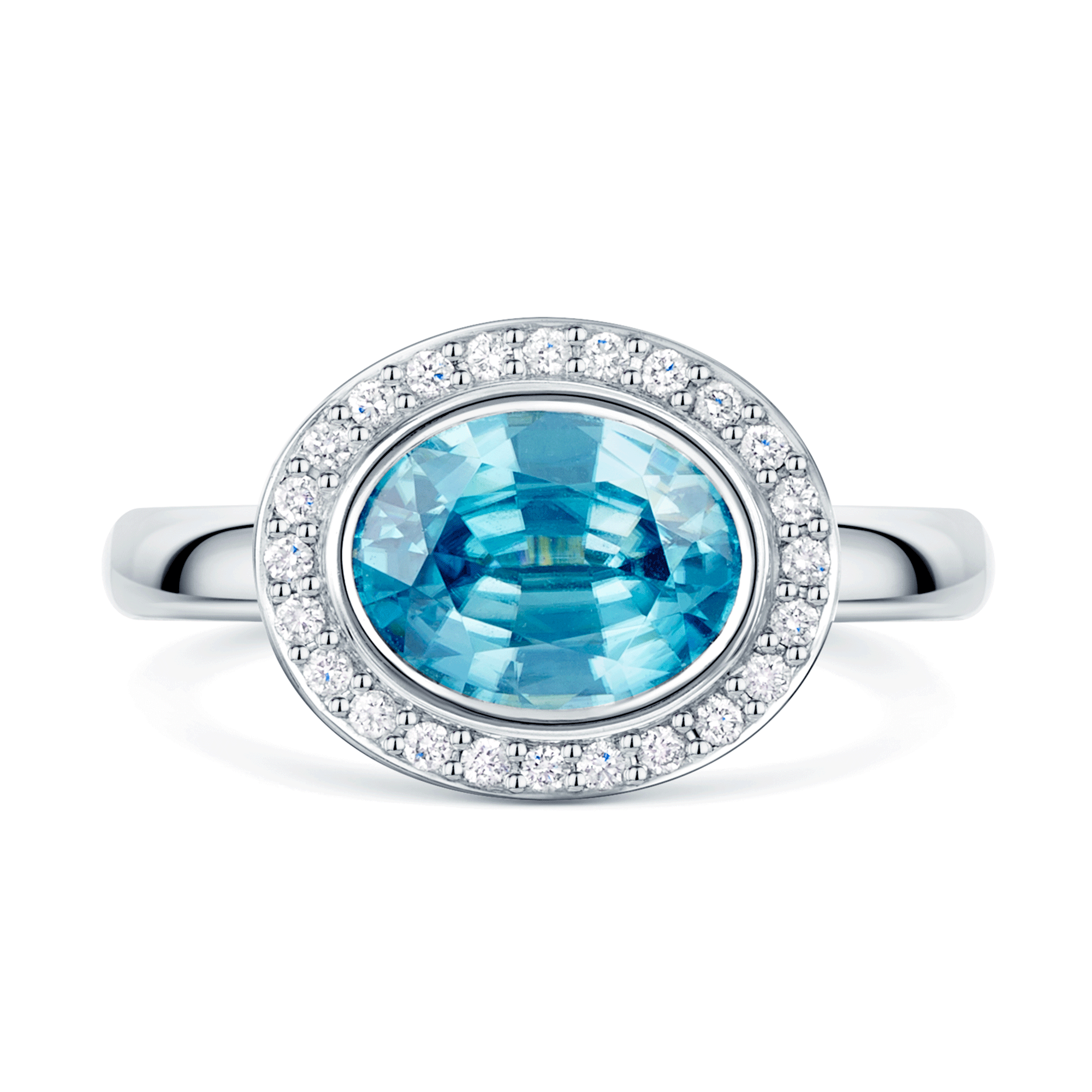 18ct White Gold Oval Cut Blue Zircon And Round Brilliant Diamond Rub Over Halo Dress Ring