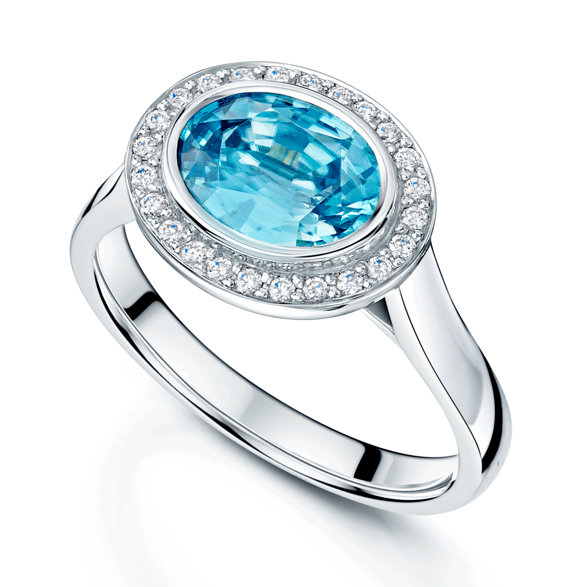 18ct White Gold Oval Cut Blue Zircon And Round Brilliant Diamond Rub Over Halo Dress Ring