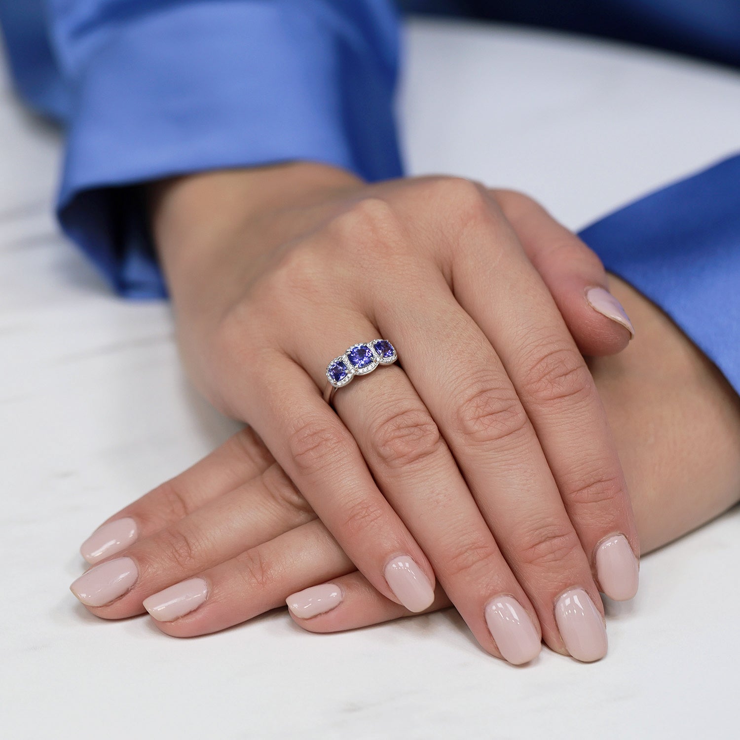 Platinum Cushion Cut Tanzanite Three Stone Ring with Diamond Halo Surround