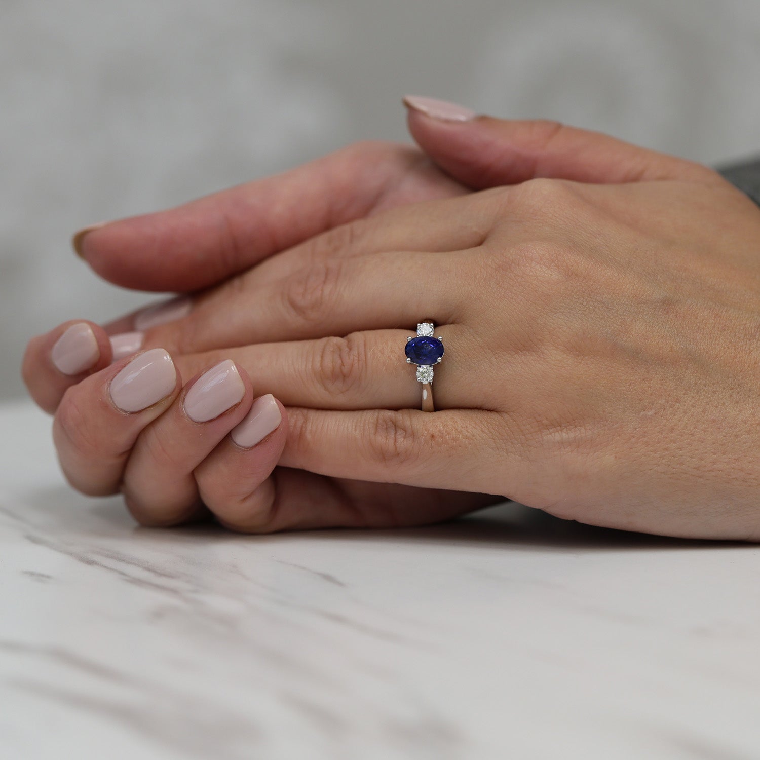 Platinum Oval Blue Sapphire & Round Brilliant Cut Diamond Three Stone Ring