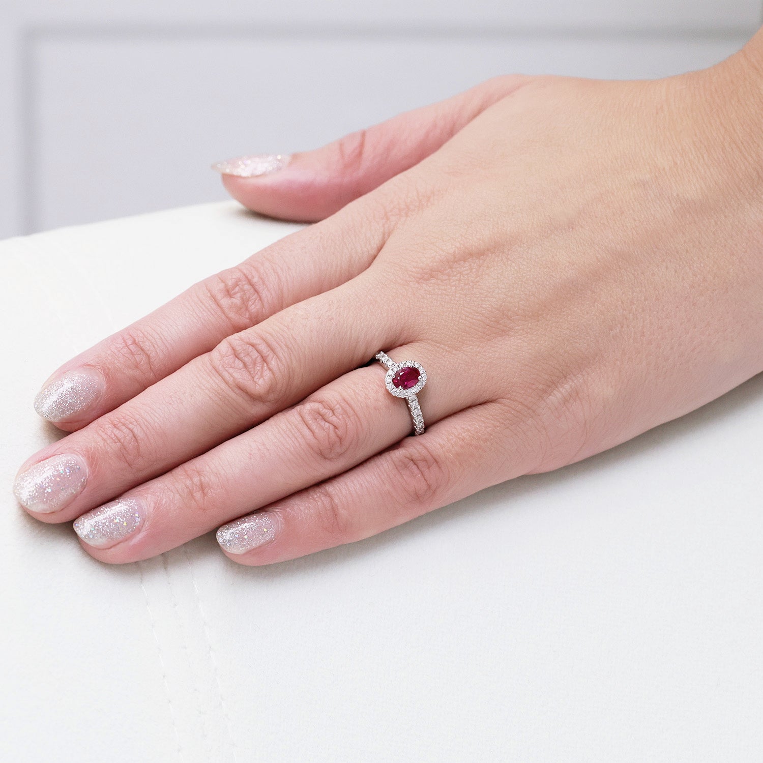 Platinum Oval Cut Ruby In a Diamond Halo Setting With Diamond Set Shoulders