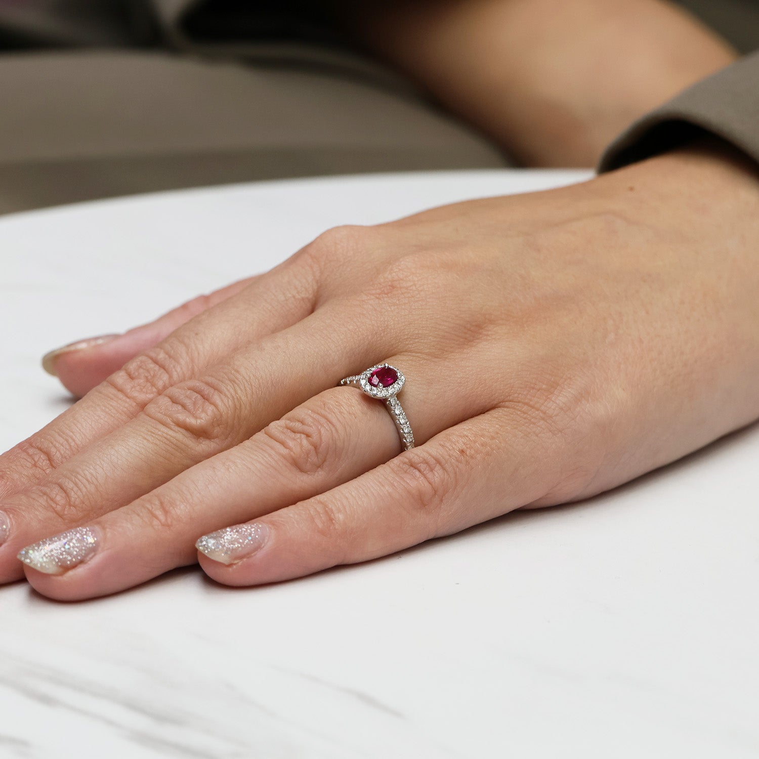 Platinum Oval Cut Ruby In a Diamond Halo Setting With Diamond Set Shoulders