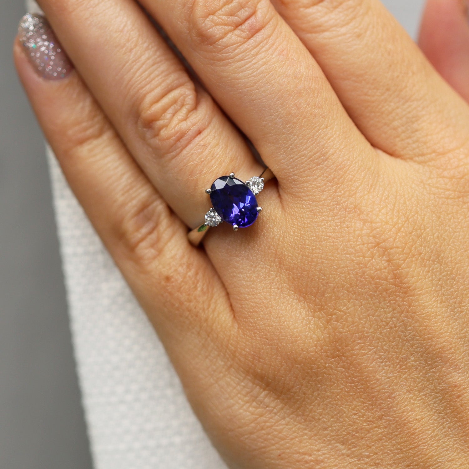 Platinum Oval Cut Tanzanite And Round Brilliant Three Stone Ring