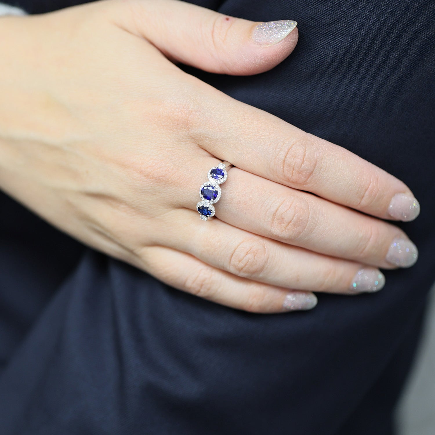 Platinum Round Brilliant Sapphire Fancy Three Stone Ring With A Diamond Halo Surround