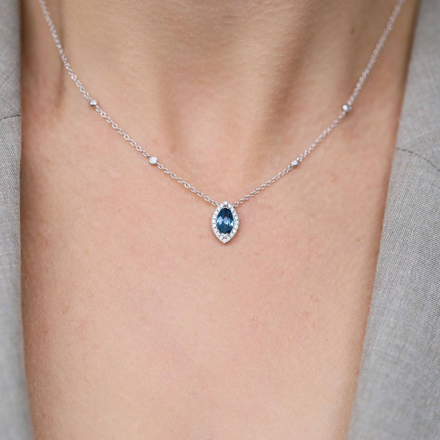 Berry's 18ct White Gold Marquise London Blue Topaz And Diamond Halo Pendant With Diamonds On The Chain - Berry's Jewellers