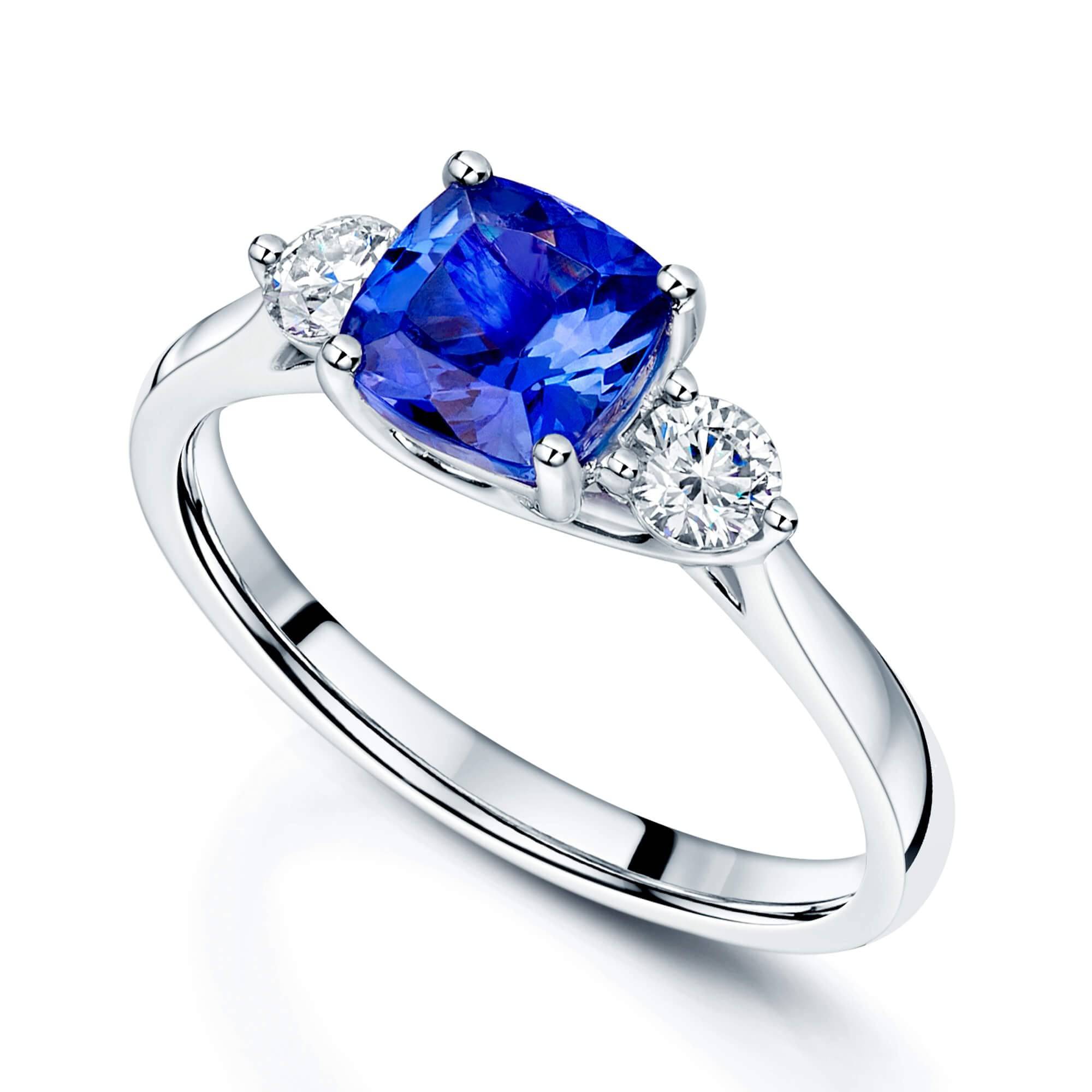 Platinum Cushion Tanzanite and Round Brilliant Diamond Three Stone Ring