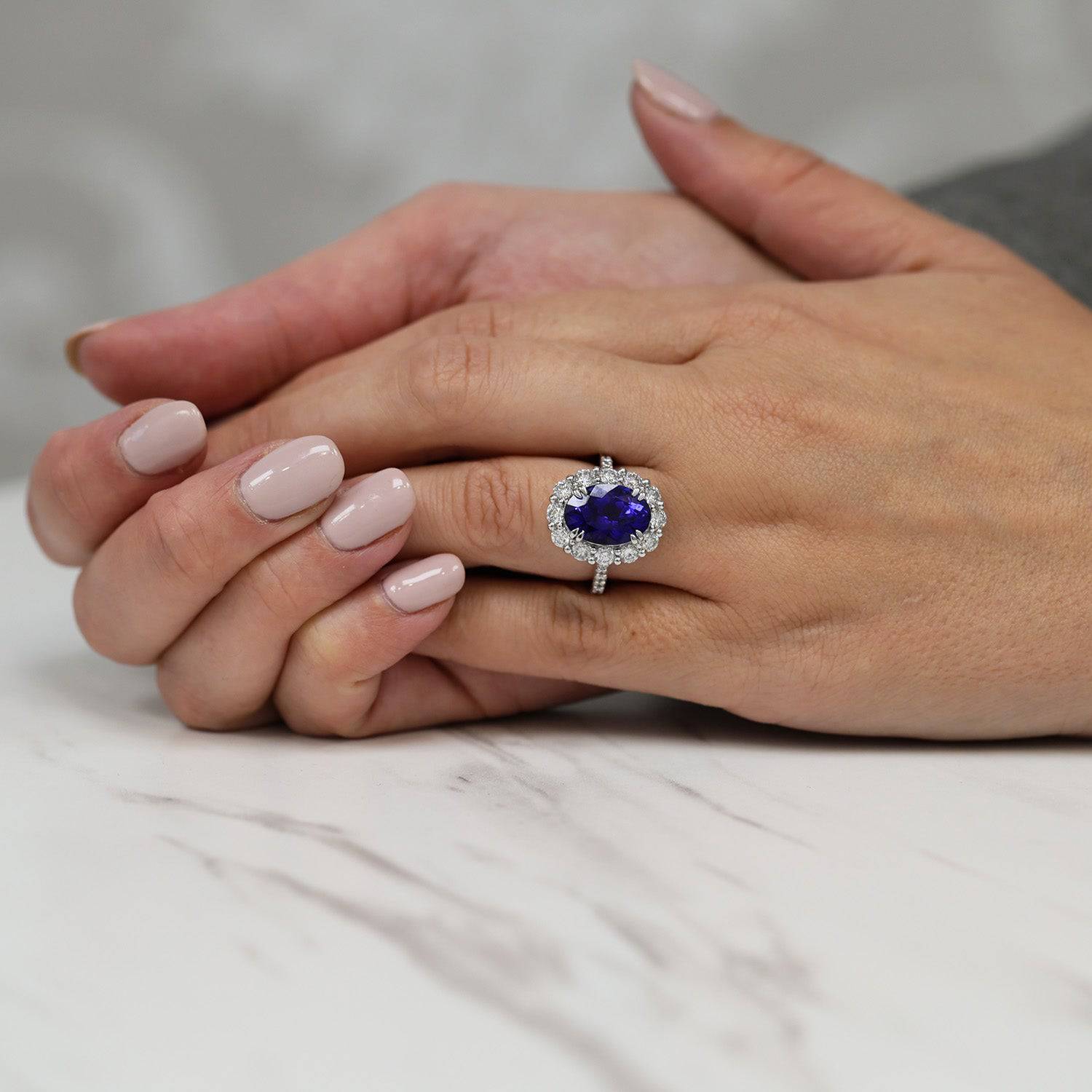 Berry's Platinum Oval Claw Set Tanzanite 5.89ct And Diamond Cluster Ring 1.70ct With Diamond Set Shoulders - Berry's Jewellers