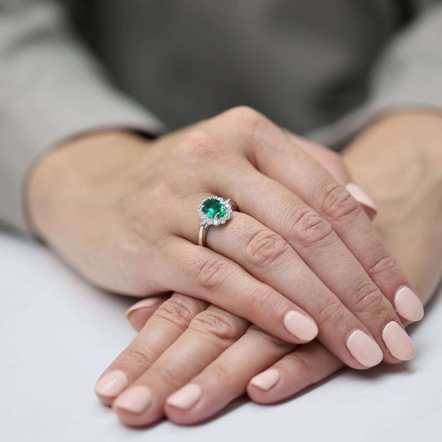 Platinum Oval Cut Emerald And Diamond Halo Cluster Ring