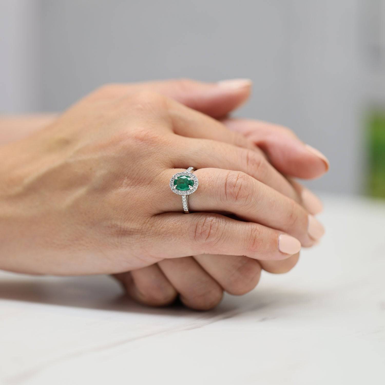 Platinum Oval Cut Emerald And Dimond Ring With Diamond Shoulders