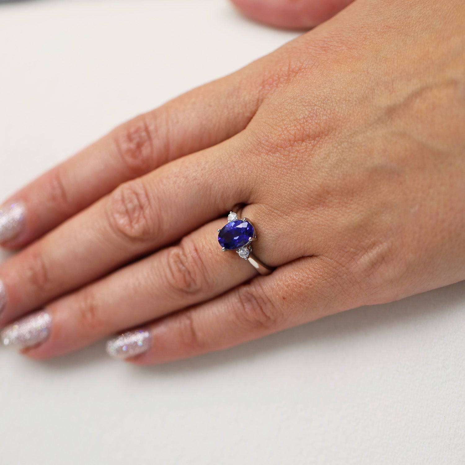 Platinum Oval Cut Tanzanite And Round Brilliant Three Stone Ring