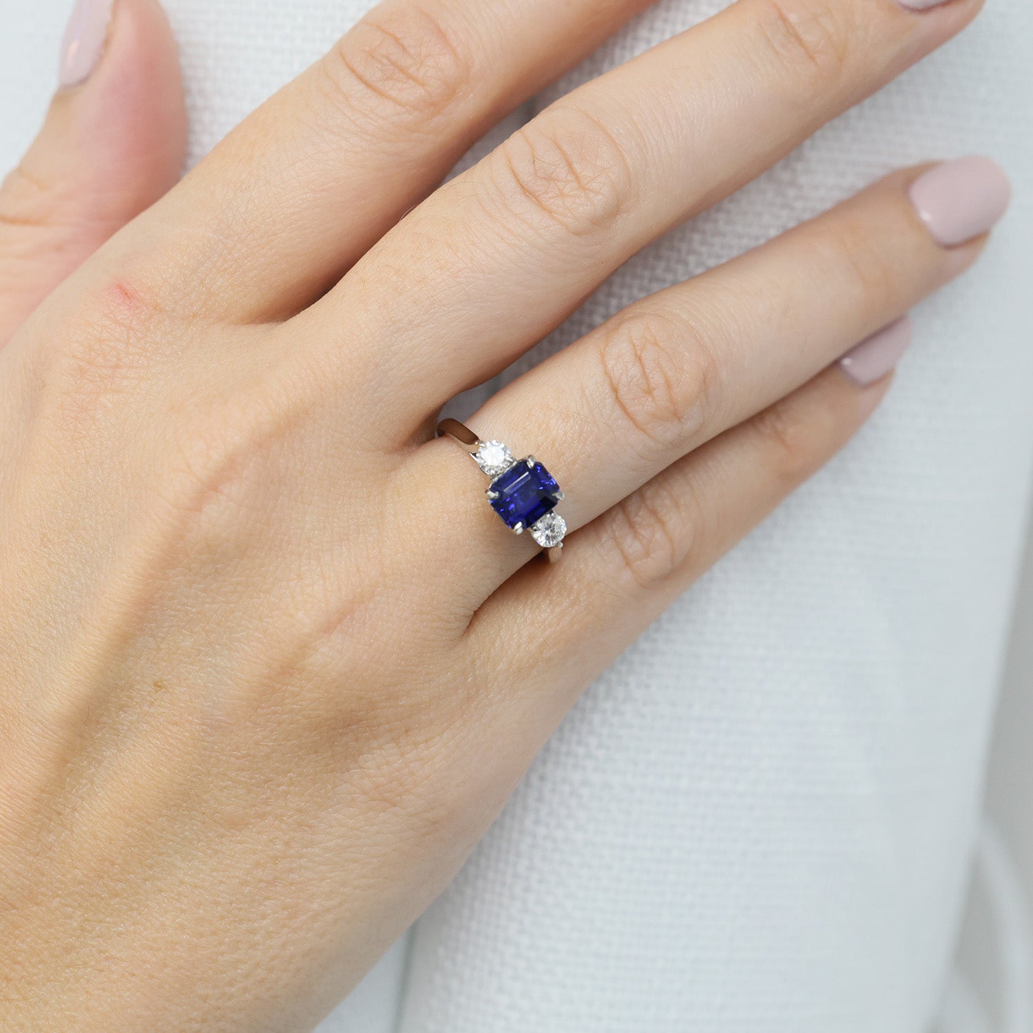 Platinum Rectangular Step Cut Sapphire & Round Brilliant Cut Diamond Three Stone Ring