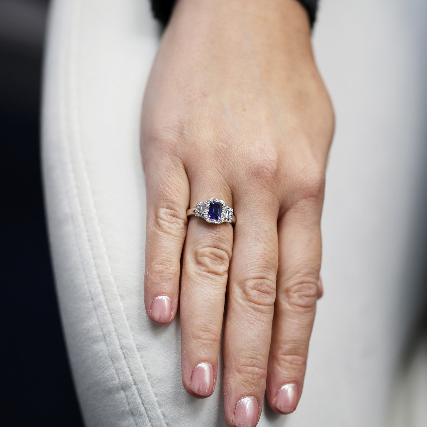 Platinum Sapphire And Baguette Cut Diamond Three Stone Ring With A Halo Surround