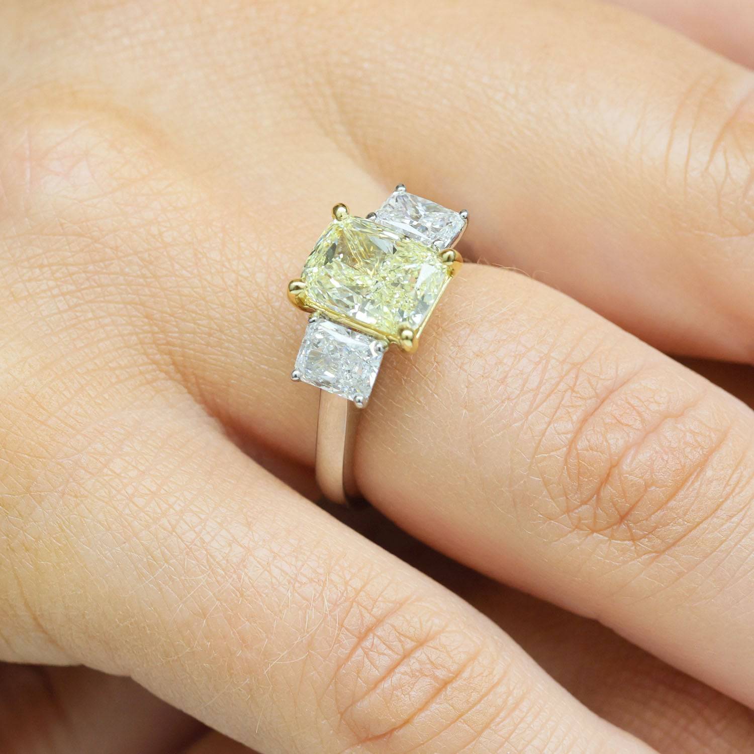 Platinum Set Fancy Yellow Radiant Cut Diamond Three Stone Ring With Radiant Cut Diamond Shoulders